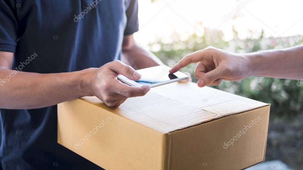 Delivery mail man giving parcel box to recipient, Young man appe