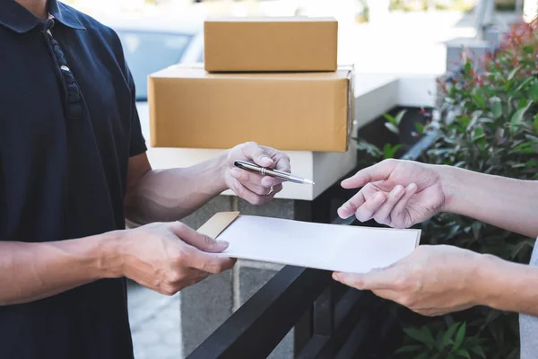 Delivery mail man giving parcel box to recipient, Young man sign