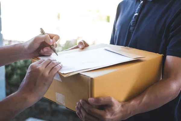 Delivery mail man giving parcel box to recipient and signature f