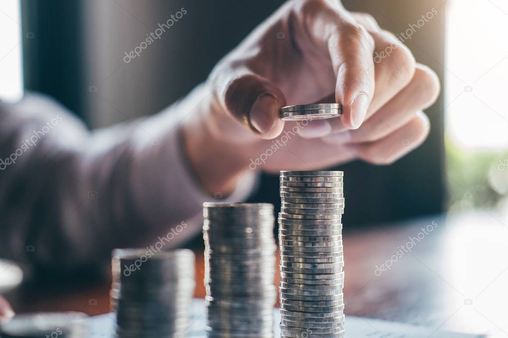 Businessman accountant counting money and making notes at report