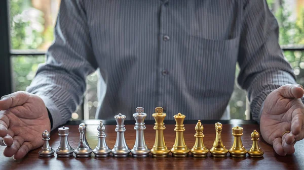 Gold and silver chess with player, Intelligent businessman playi