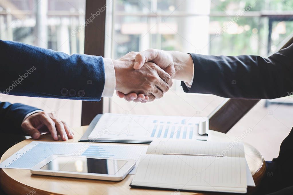 Finishing up a meeting, handshake of two happy business people a