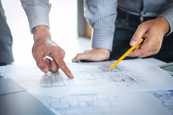 Construction engineering or architect discuss a blueprint while — Stock Photo, Image