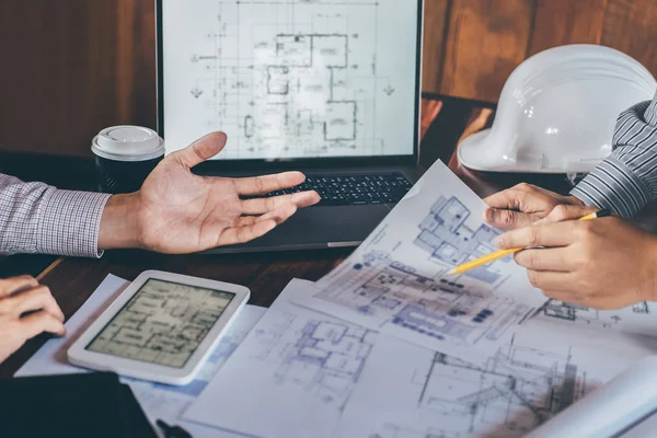 Construction engineering or architect discuss a blueprint while — Stock Photo, Image