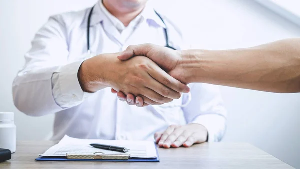stock image Doctor having shaking hands to congrats with patient after recom