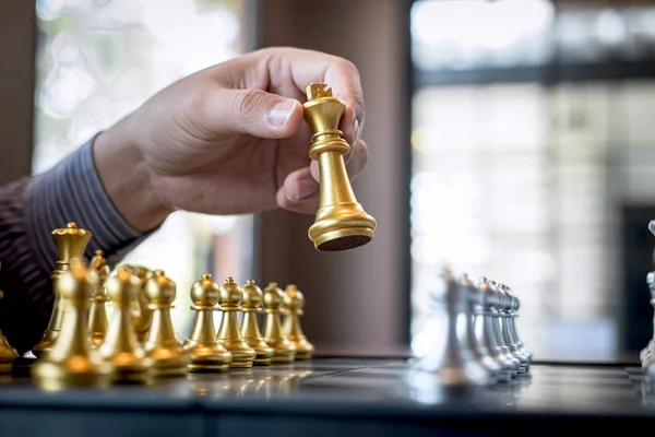 Gold and silver chess with player, Intelligent businessman playi