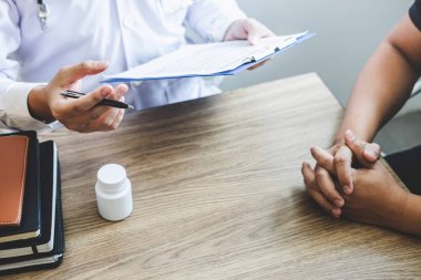Beyaz üniformalı önlük lü profesyonel doktor ve hasta discu