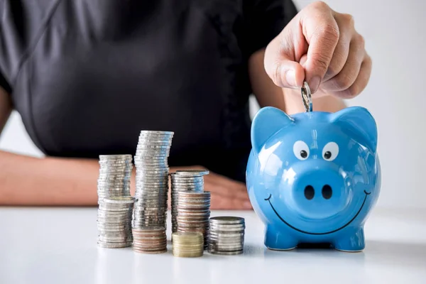 Images of stacking coins pile and woman hand putting coin into b — Stock Photo, Image