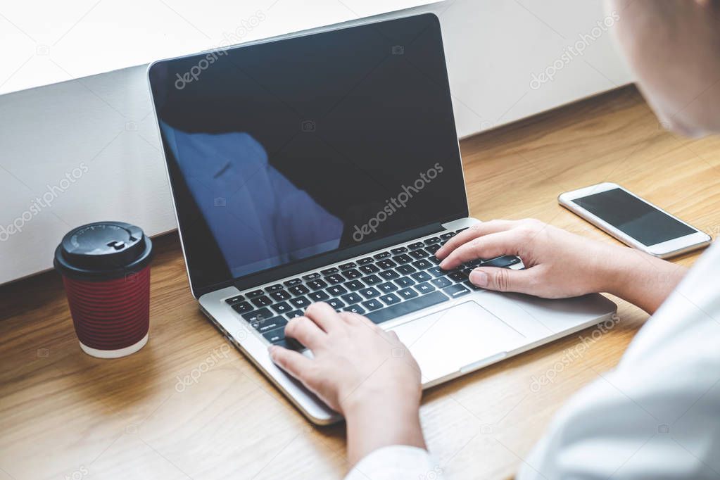 Image of Young woman working in front of the laptop looking at s