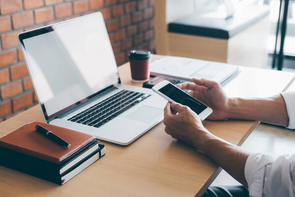 Image of Young man working in front of the laptop looking at scr