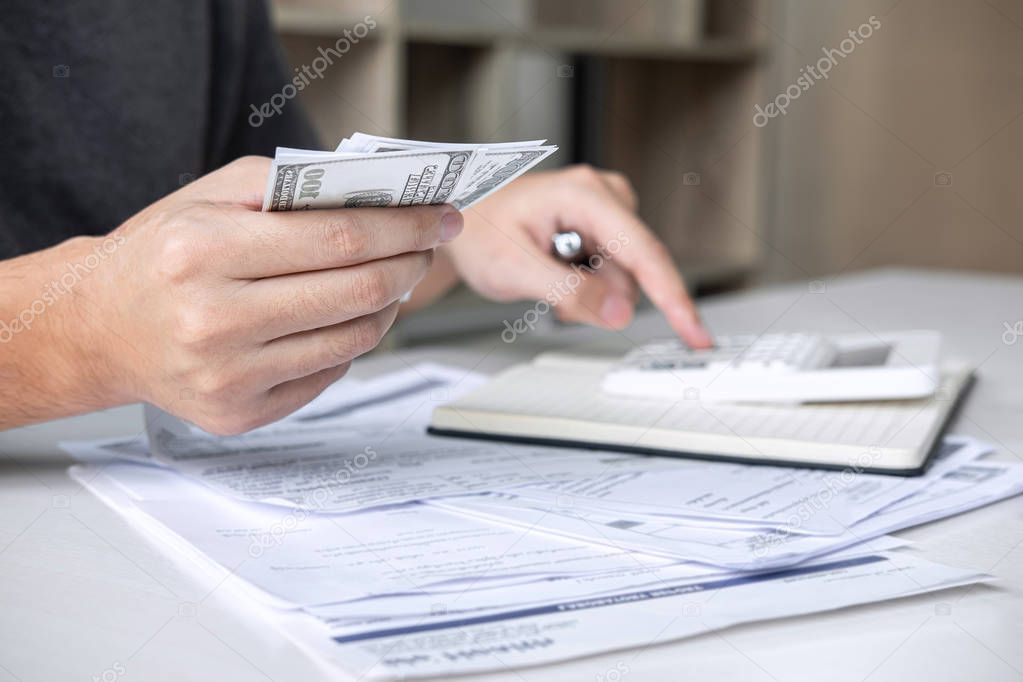 Images of Husband using calculator to calculating expenditure re