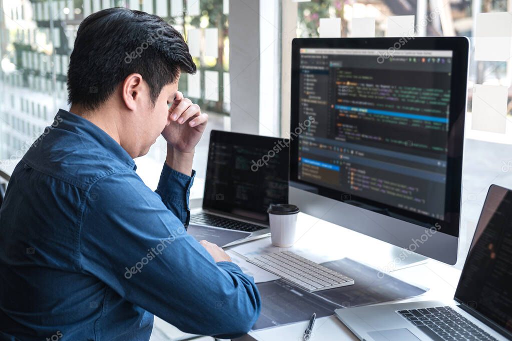 Stressed tired out of work, Development Programmer working in programming website a software and coding technology, writing codes and data code, Programming with HTML, PHP and javascript.