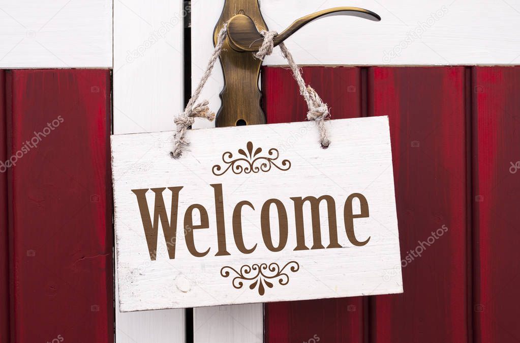Wooden signboard with message welcome