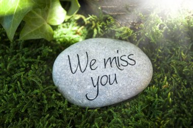 Grey stone in the forest with we miss you clipart