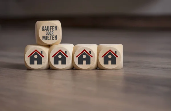 Cubes dice with the german words for buy or rent - kaufen oder mieten and house icons