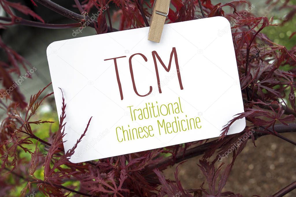 Red japanese maple with card board and TCM traditional Chinese medicine