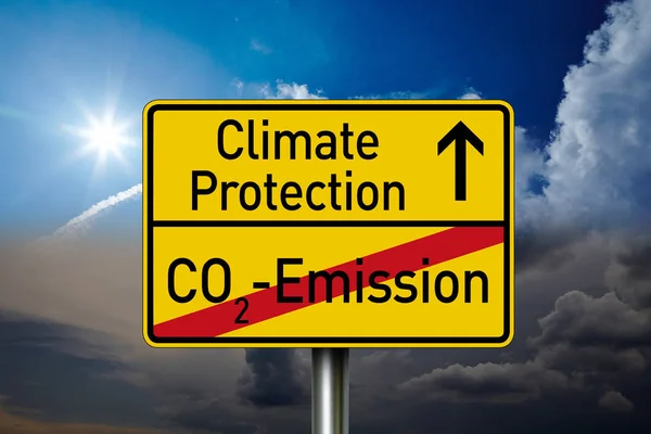 Traffic sign with climate protection, co2 emission and co2 tax with clouds in the background