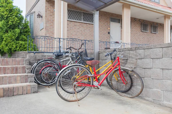 Many bicycle parked at bicycle parking space in front of home residential