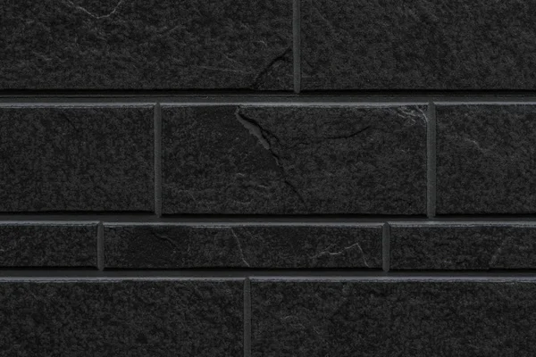 seamless black stone tile wall pattern and background