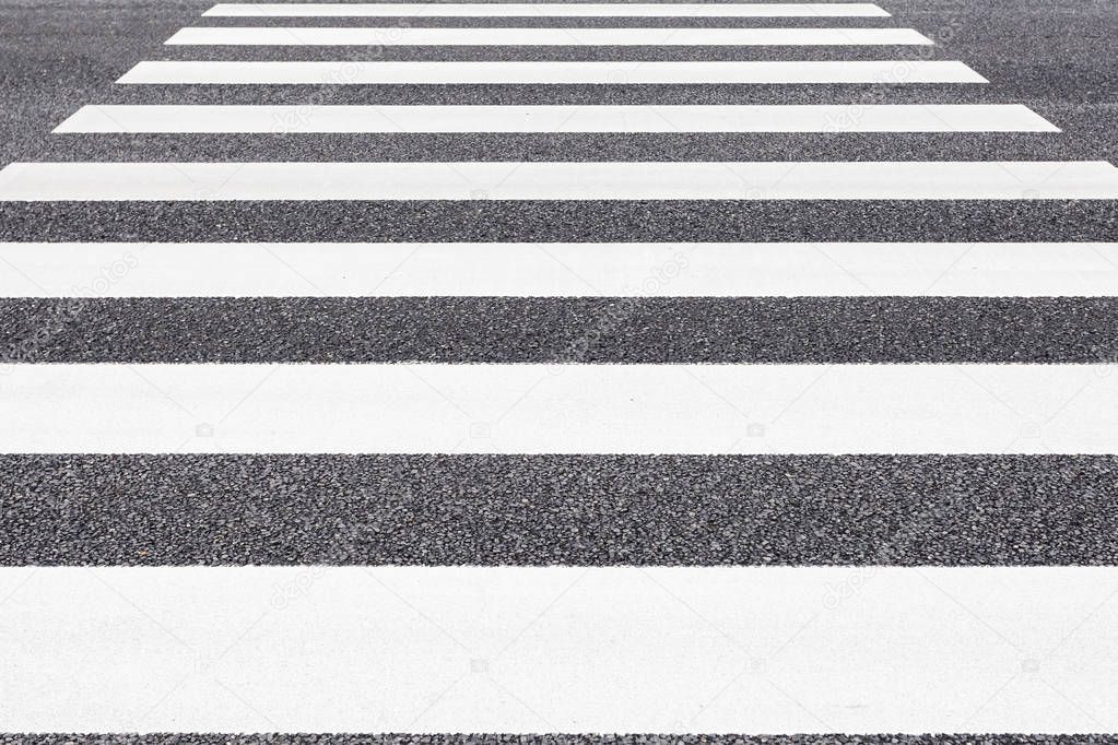 Closeup of zebra crossing pattern on city road