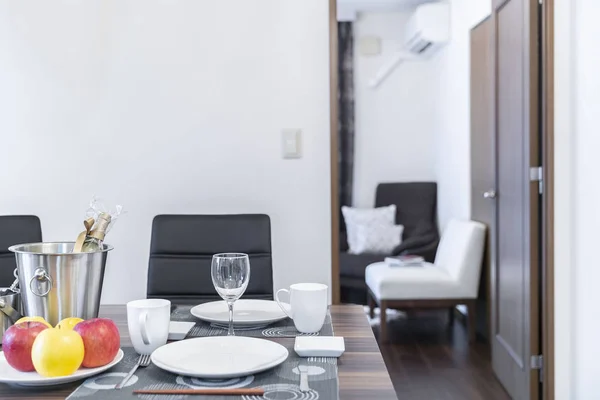 A set of dishes and a glass of wine on the dinner table