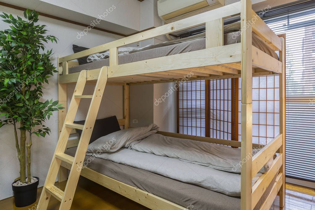 Brown double-decker bed in a small bedroom