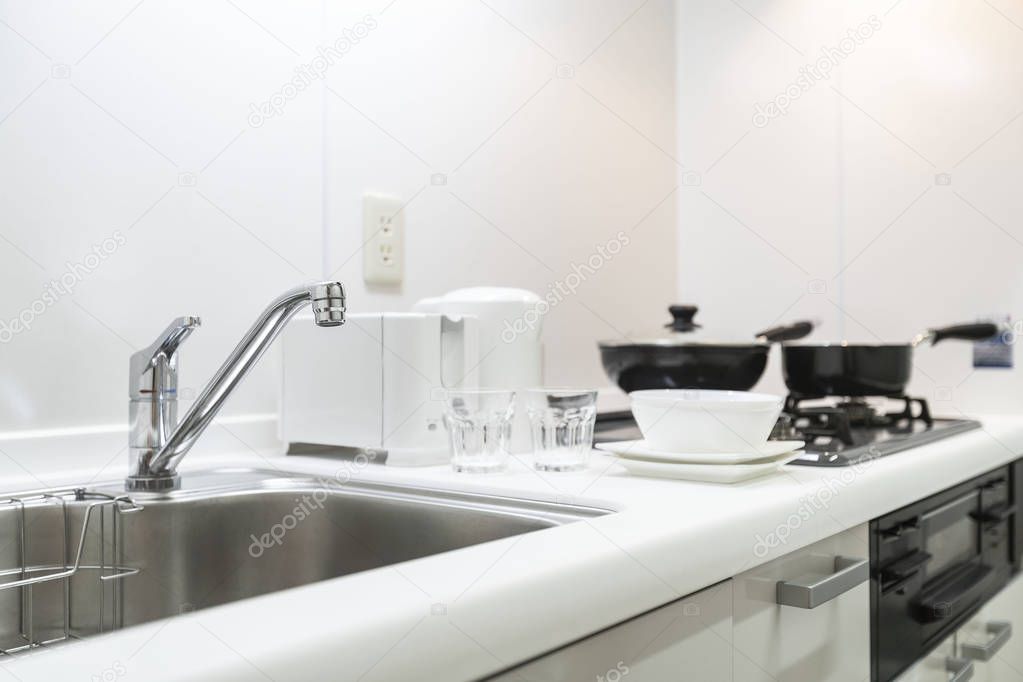 Sink at the small kitchen cabinet in the apartment room