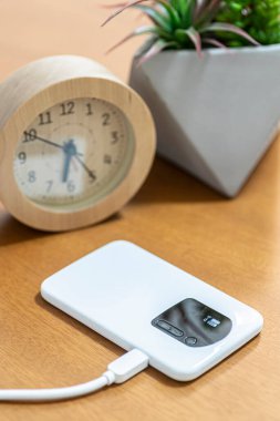 Mobil kablosuz ağ yönlendirici oturma odasındaki masanın üzerine yerleştirilmiş.