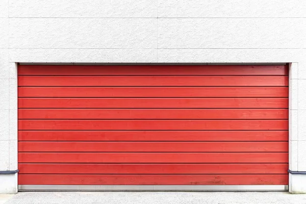 Automatic red roller shutter doors on the ground floor of the house