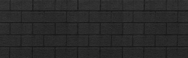 Siyah taş blok duvar panoraması. Kusursuz arkaplan ve desen dokusu.