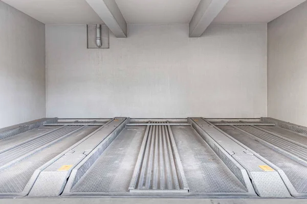 Empty automatic car Parking lift the basement in the office building