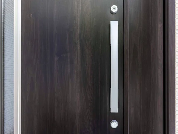 Modern door handle with security system lock on metal door