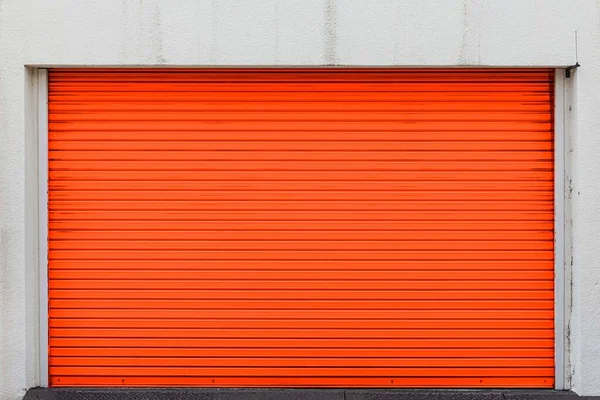 Automatic red roller shutter doors on the ground floor of the house