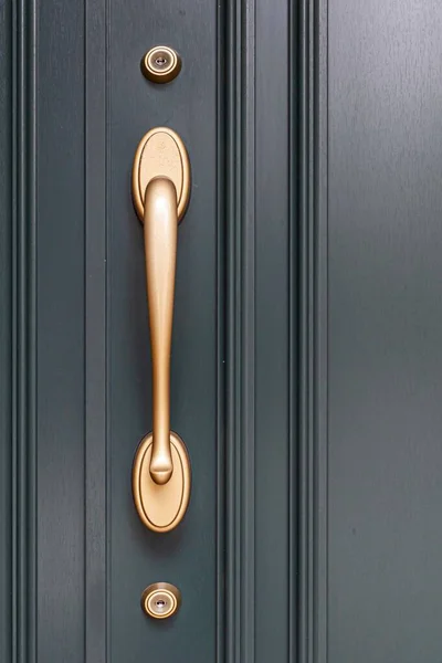 Modern door handle with security system lock on metal door