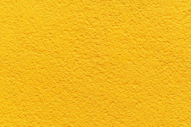 Sert desenli sarı beton duvar dokusu ve pürüzsüz arka plan.