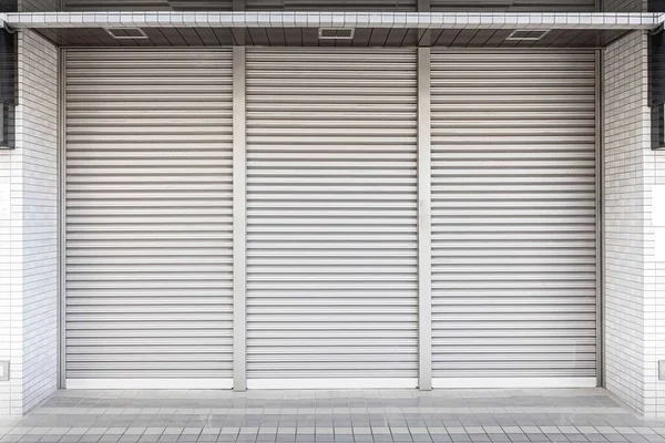 Automatic white roller shutter doors on the ground floor of the house