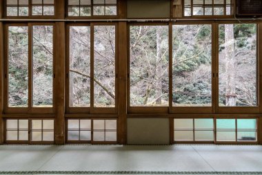 Japanese-style wooden windows looking out over the natural trees clipart