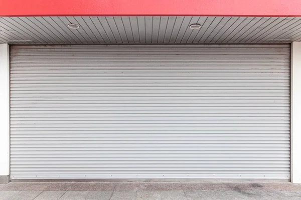 Automatic white roller shutter doors on the ground floor of the house