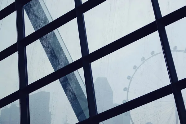 rain water drops On Window Glass with Ferris wheel background