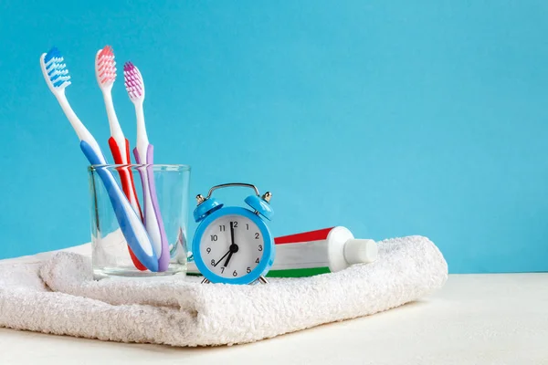 Healthy Teeth Toothbrushes Toothpaste Bath Towel Alarm Clock Table Bathroom — Stock Photo, Image