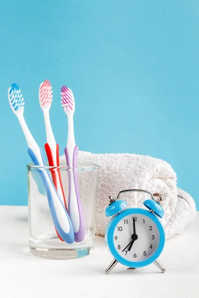 Healthy Teeth Toothbrushes Toothpaste Bath Towel Alarm Clock Table Bathroom — Stock Photo, Image