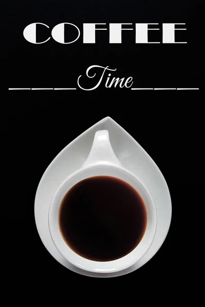 White cup of coffee on a black background with the text coffee time. Close-up with copy space for text in minimalism style. Flat top view