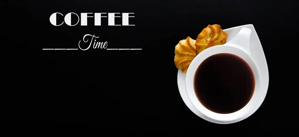 White cup of coffee on a black background with the text coffee time. Close-up with copy space for text in minimalism style. Flat top view