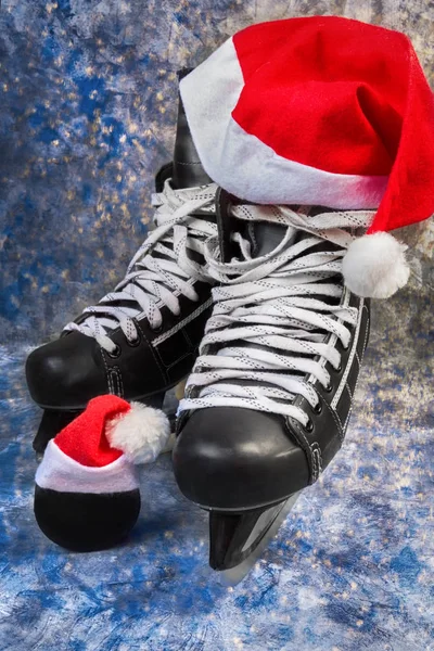 Ice hockey skates and puck symbol of winter Christmas tournaments
