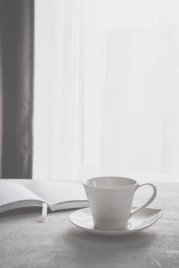 İskandinav tarzı minimalizm ile kopya alanı gri ölçekte bir pencerede yakınındaki bir masada kahve