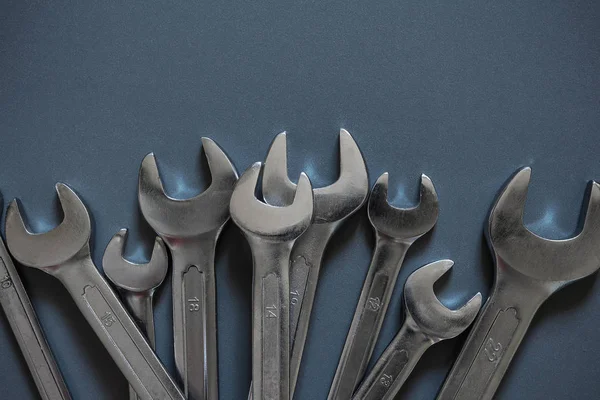 Set of tools for repairing spanners on a gray background with copy space flat lay top view