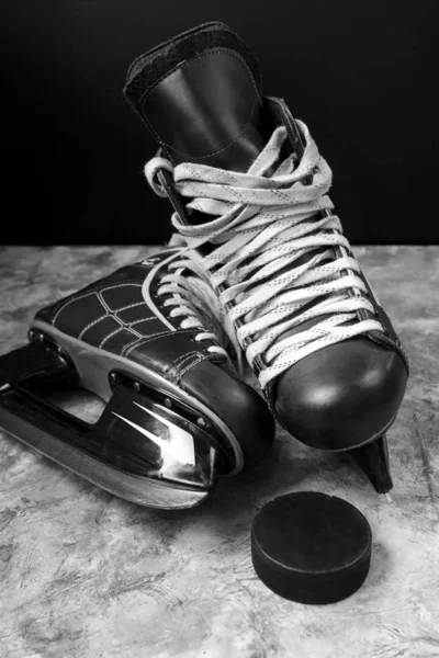 Ice hockey skates and puck symbol of winter Christmas tournaments