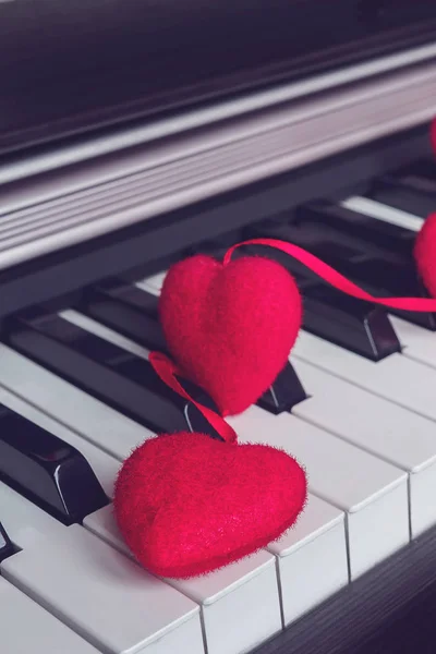 Musical instrument piano with decoration garland of hearts concept love,holiday of Valentine\'s Day