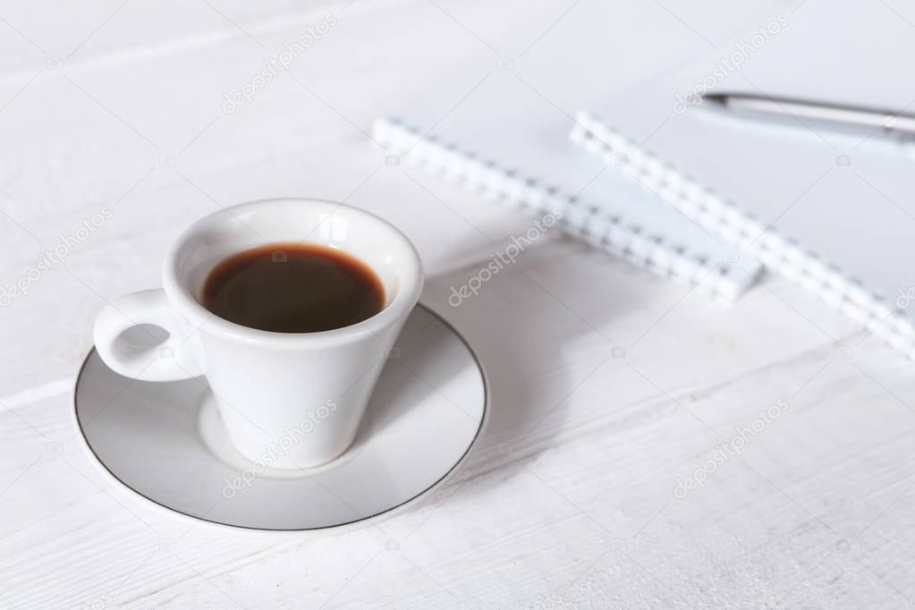 Stylish workspace with notebook, cup of coffee, paper blank, pencils. Business concept. Flat lay, top view