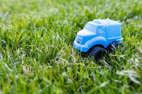 Vintage baby blue car on green grass, ecology of transport and environmental pollution